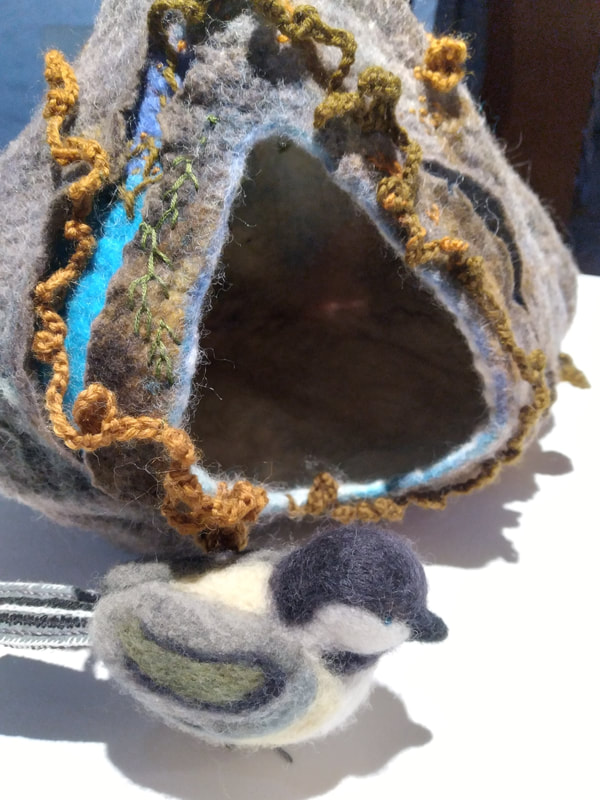 Nest and chickadee. Wet-felted and needle-felted wool. Embroidery and crocheting.